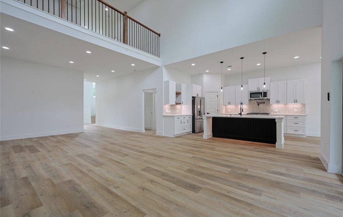 Open-plan kitchen seen across a wide living area
