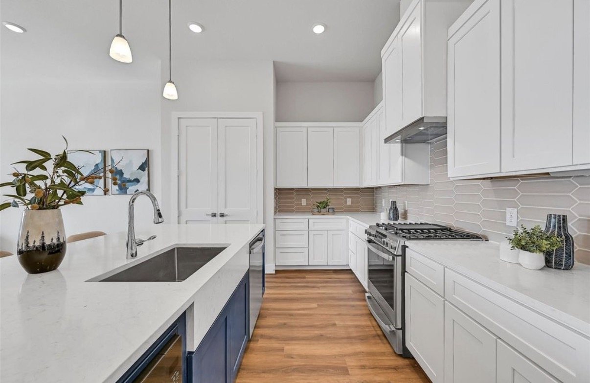Kitchen counter and cabinetry detail with a quartz worktop