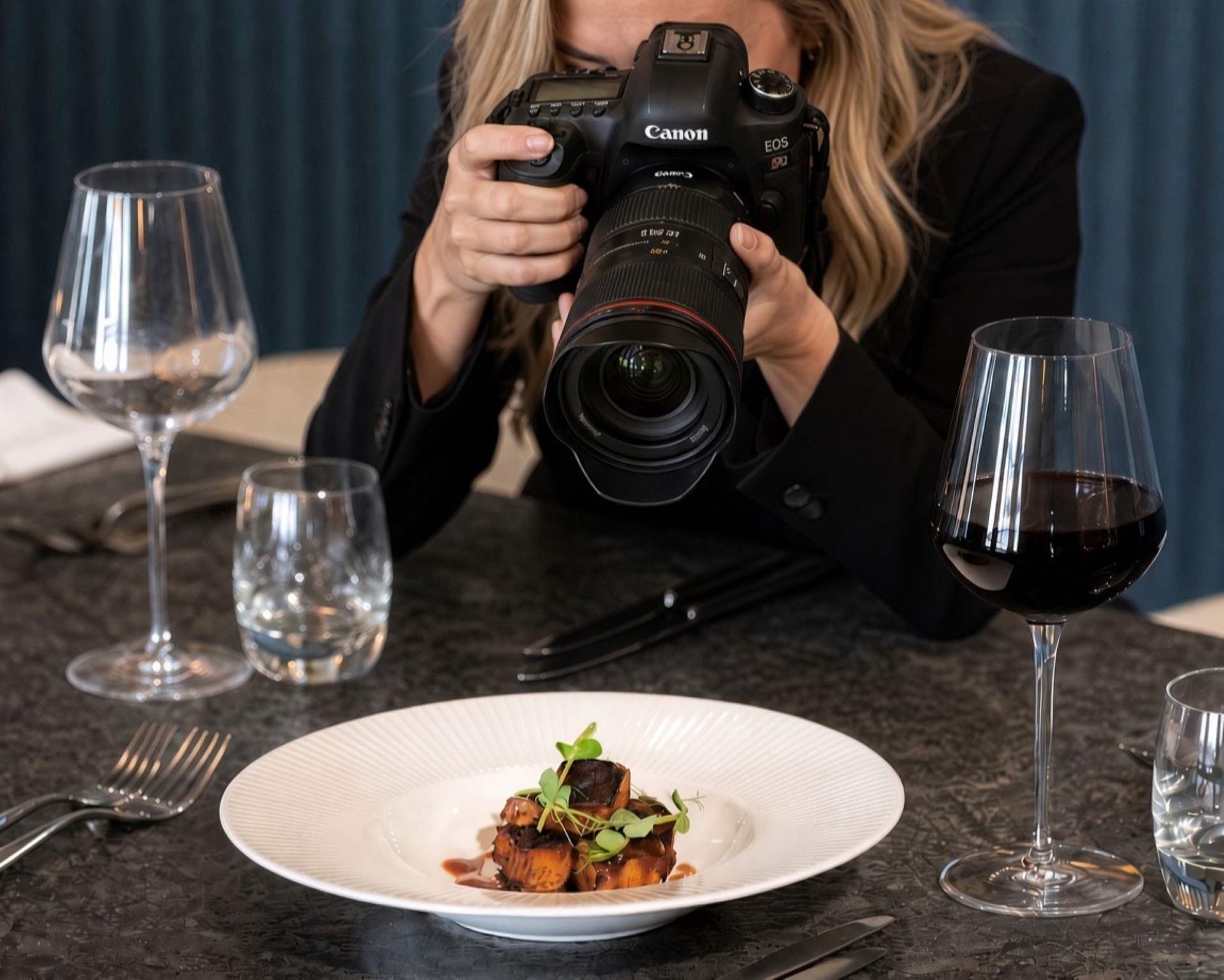 Photographer shooting a fine dining dish and red wine for a Hospa hotel marketing campaign
