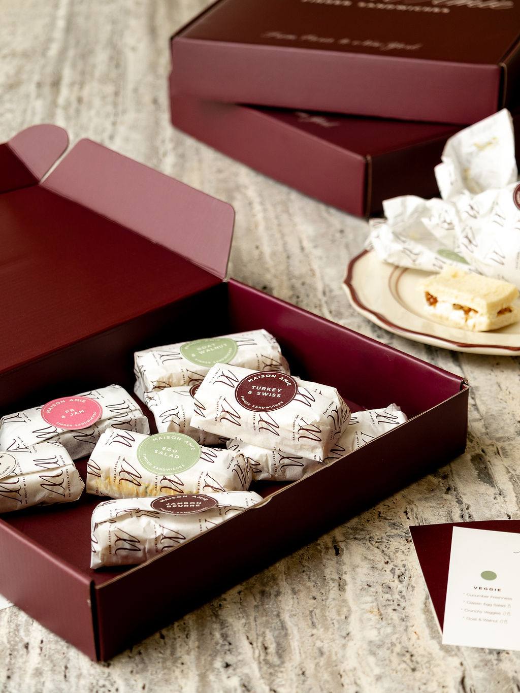 A table set with Maison Amie discovery boxes
