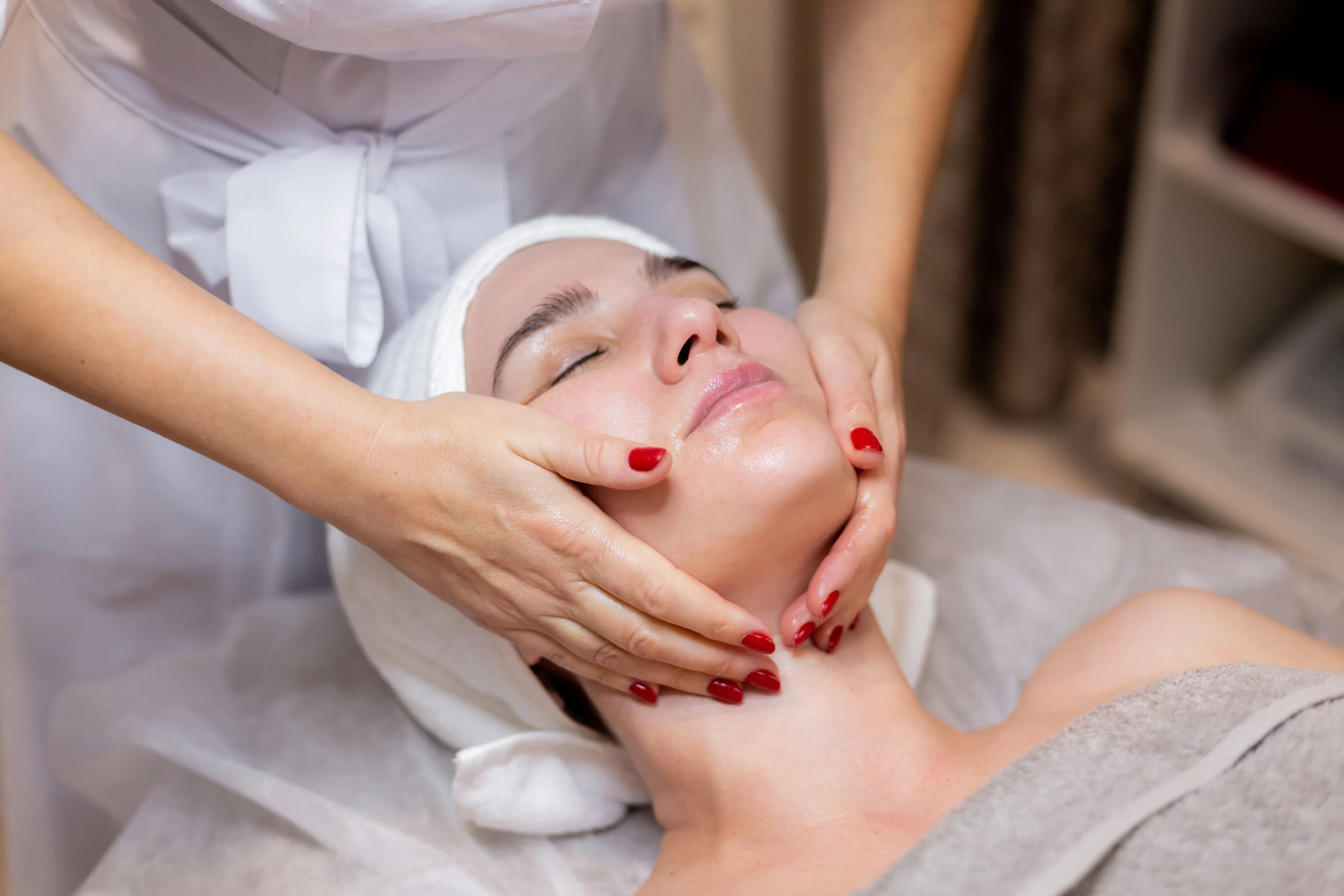 Professional facial massage treatment in a calm clinical spa setting
