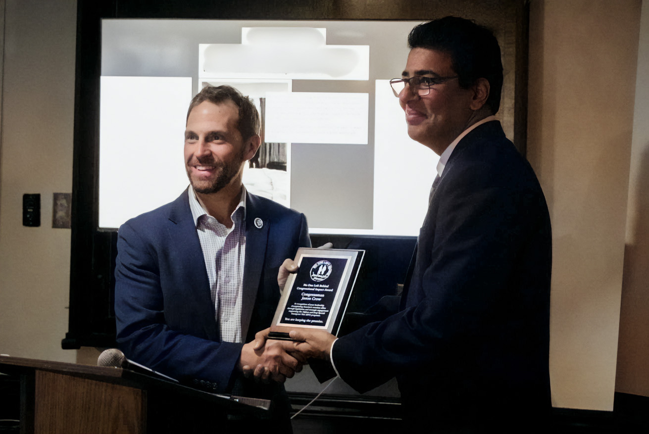 Janis Shinwari presents Rep. Jason Crow (D-CO) with No One Left Behind's Congressional Impact Award.