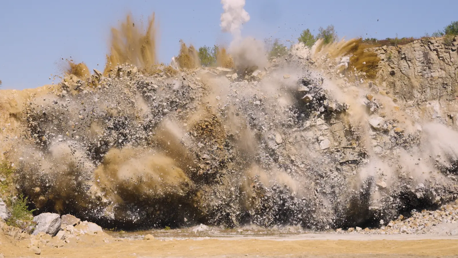 Rock and dust rising during a Capital Rock controlled blast.