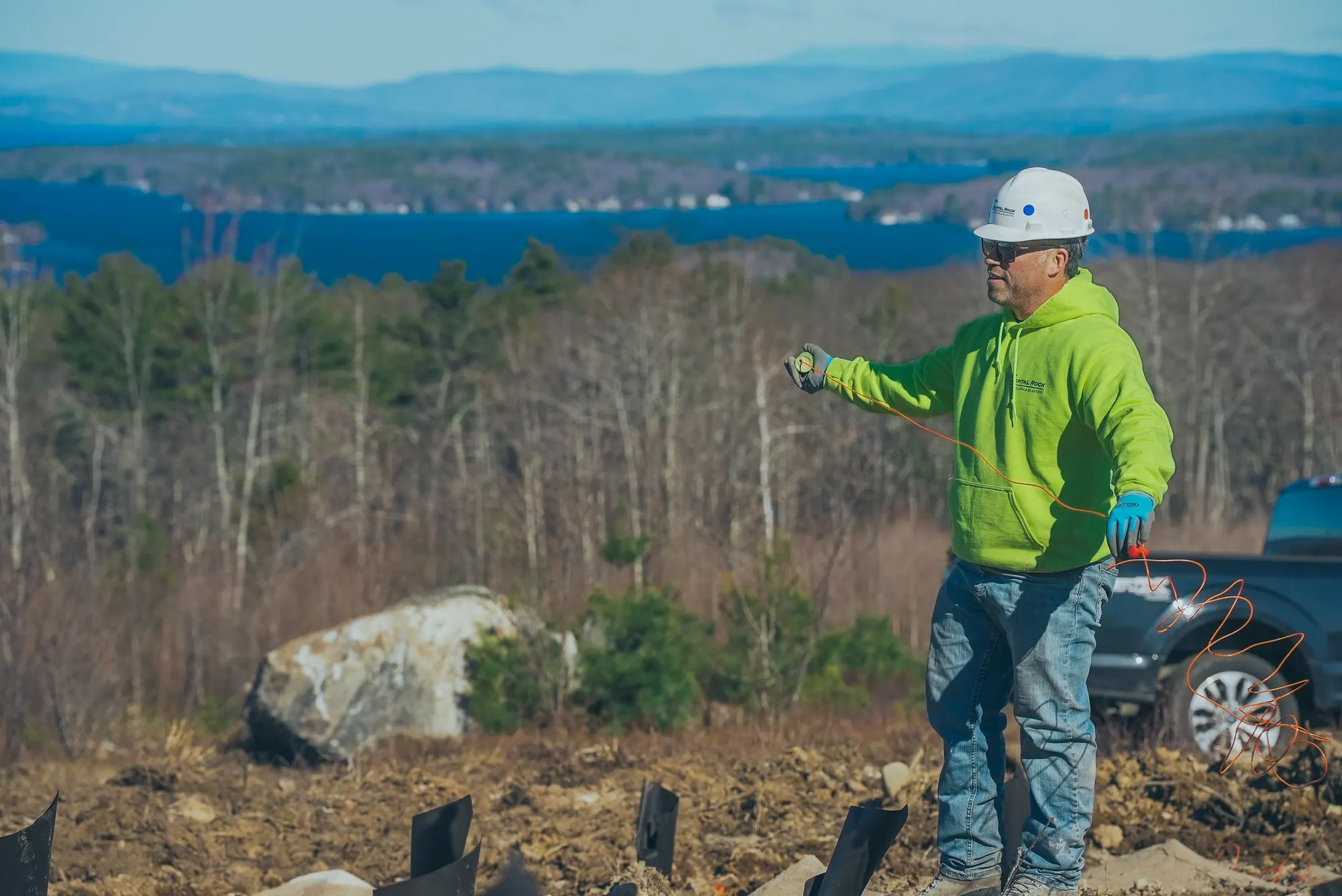 Crew member preparing cords on an active rock-work site