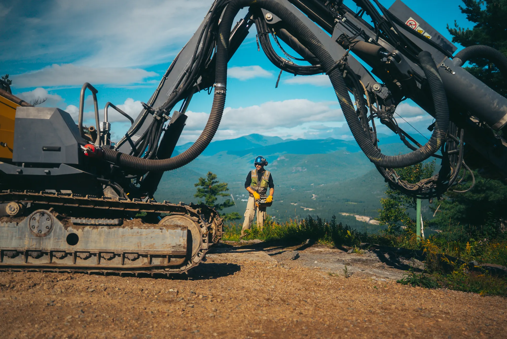 Crew member working beside a large drill rig