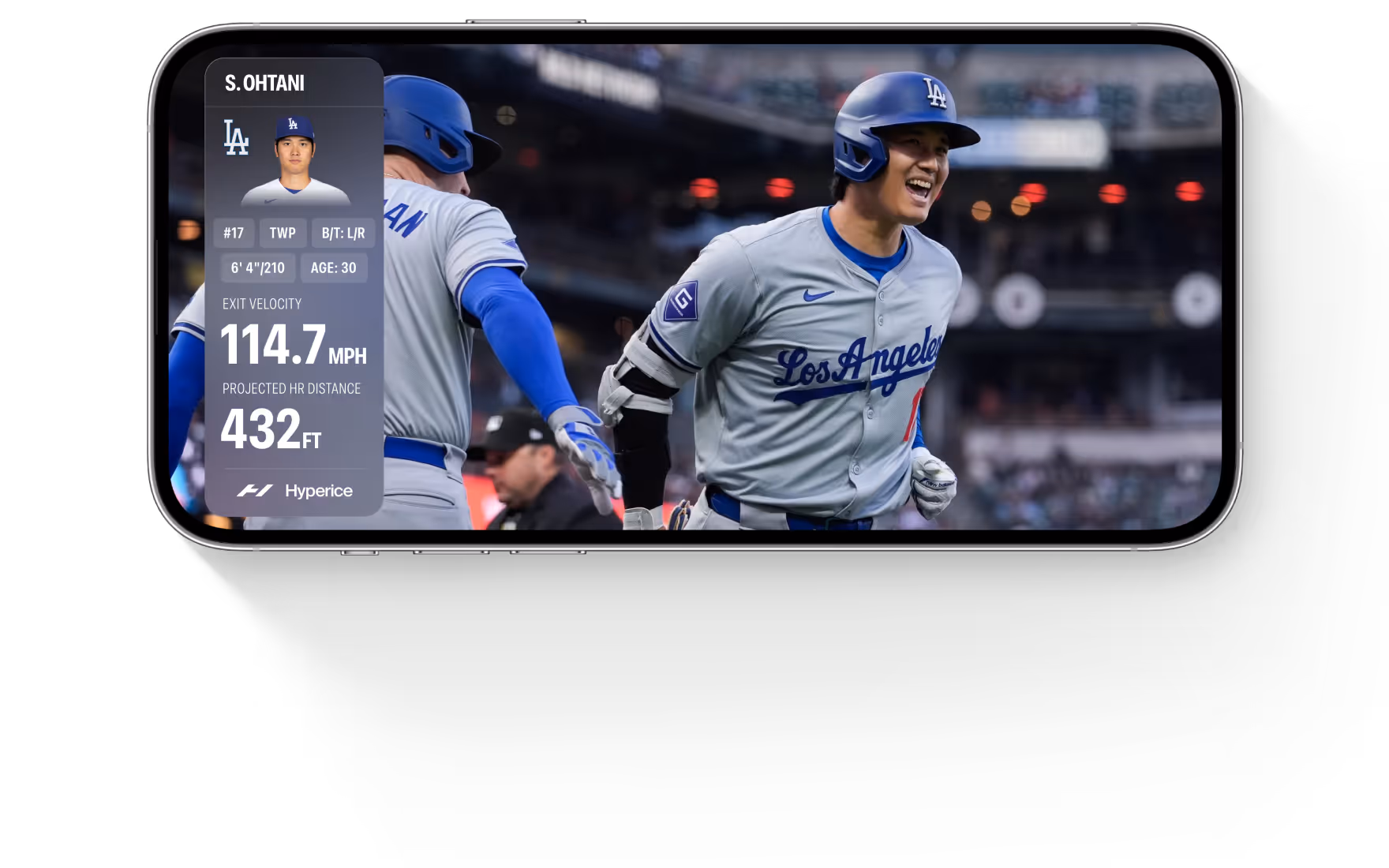 Baseball player Shohei Ohtani in Los Angeles Dodgers uniform celebrating on field with performance stats overlay showing 114.7 mph exit velocity and 432 ft projected home run distance.