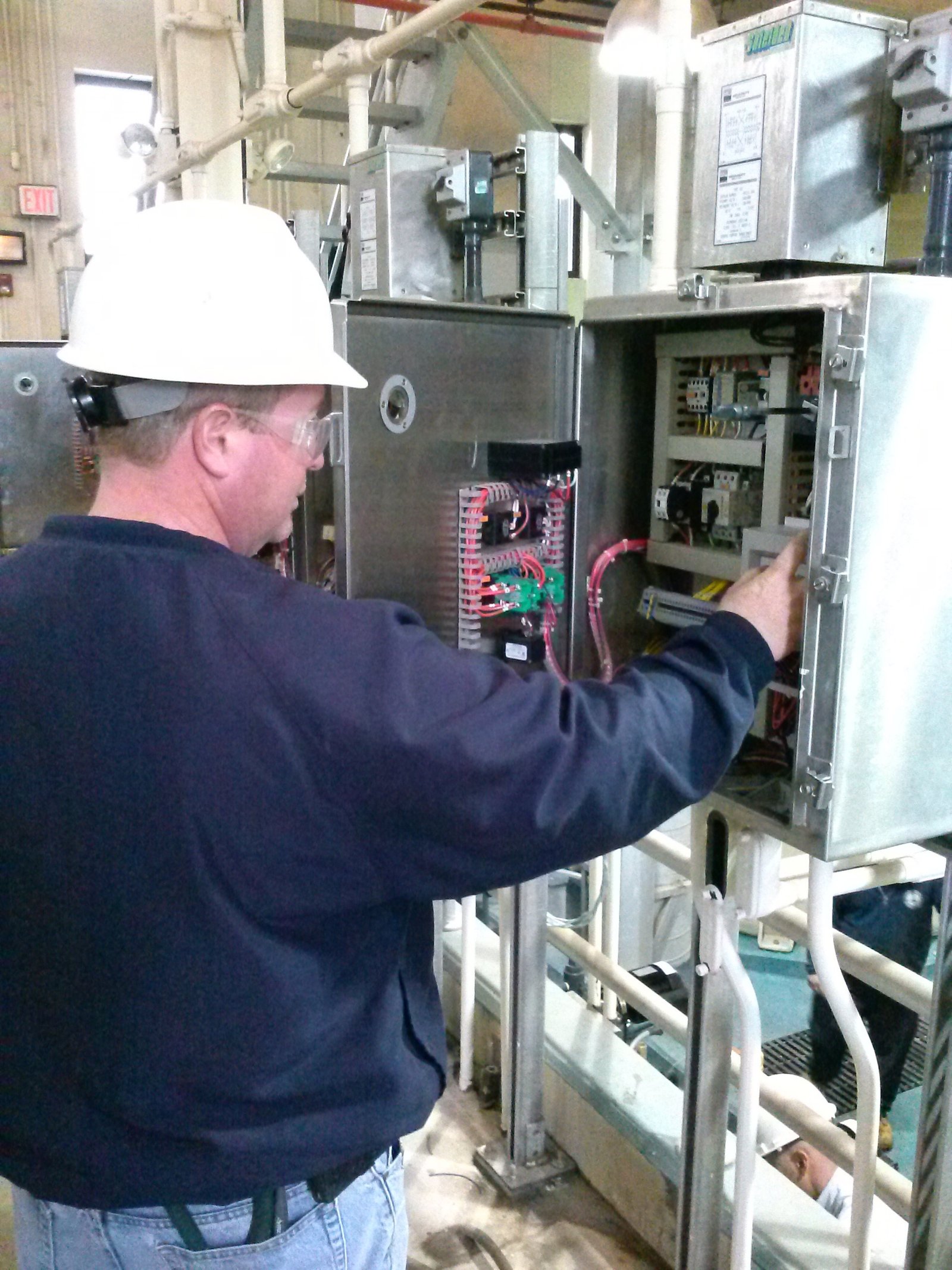 LAVAN technician working beside an open electrical cabinet