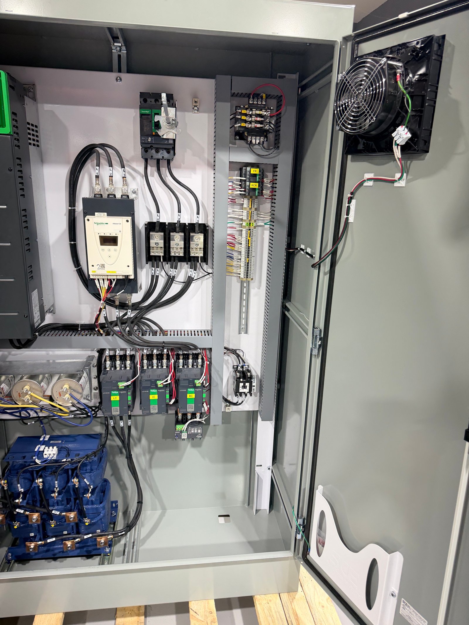 Open custom electrical control panel with organized drives and control components
