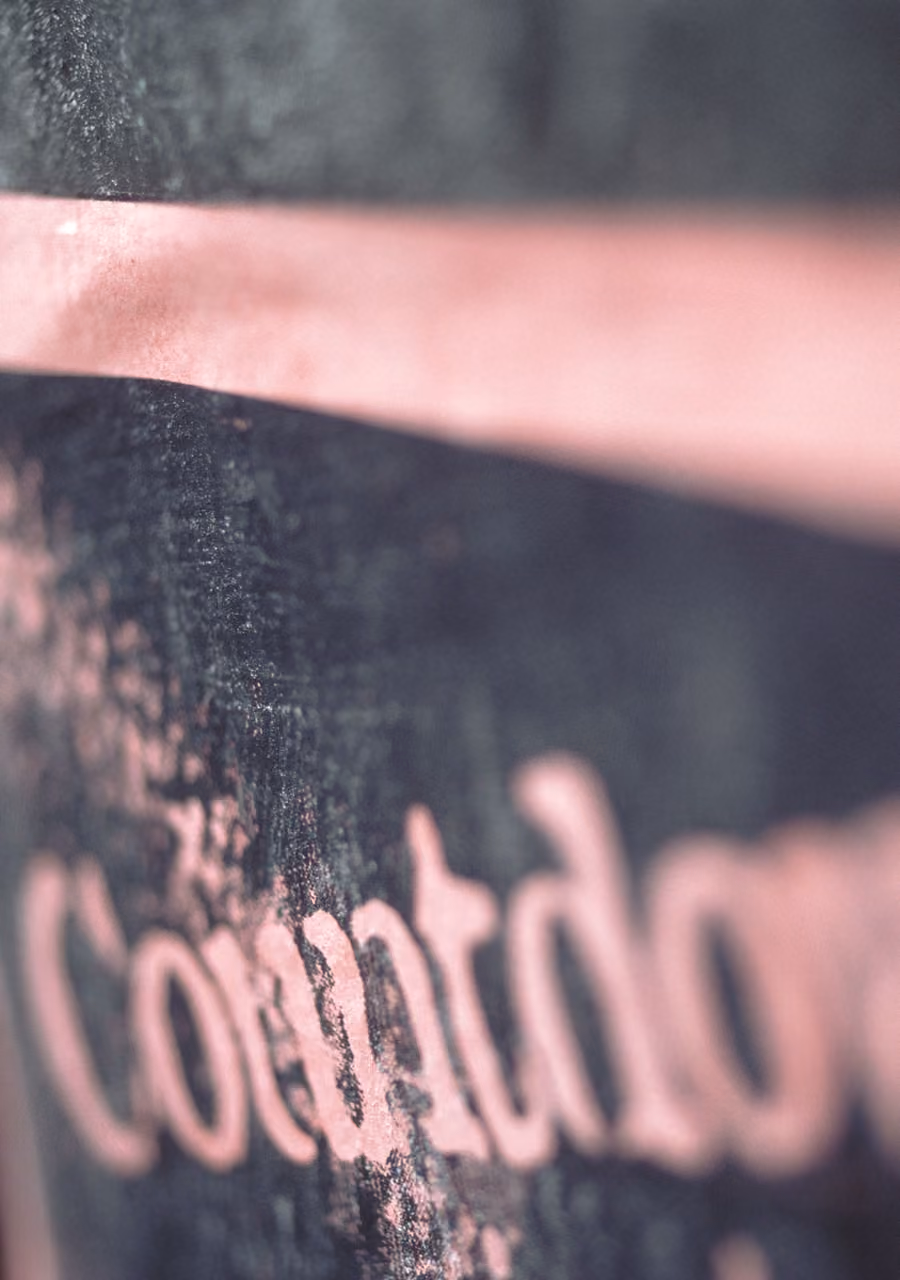 Close-up of a chalkboard with the pink word 'Countdown' partially visible and blurred.