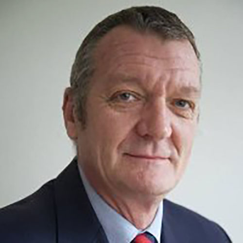 Portrait of a man, Ian B., in a suit and tie against a plain background.