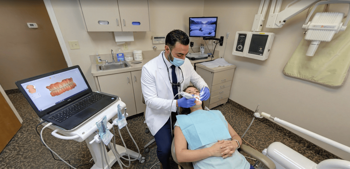 Dr. Khaddor uses an intraoral scanner for a detailed digital dental exam, capturing teeth impressions.