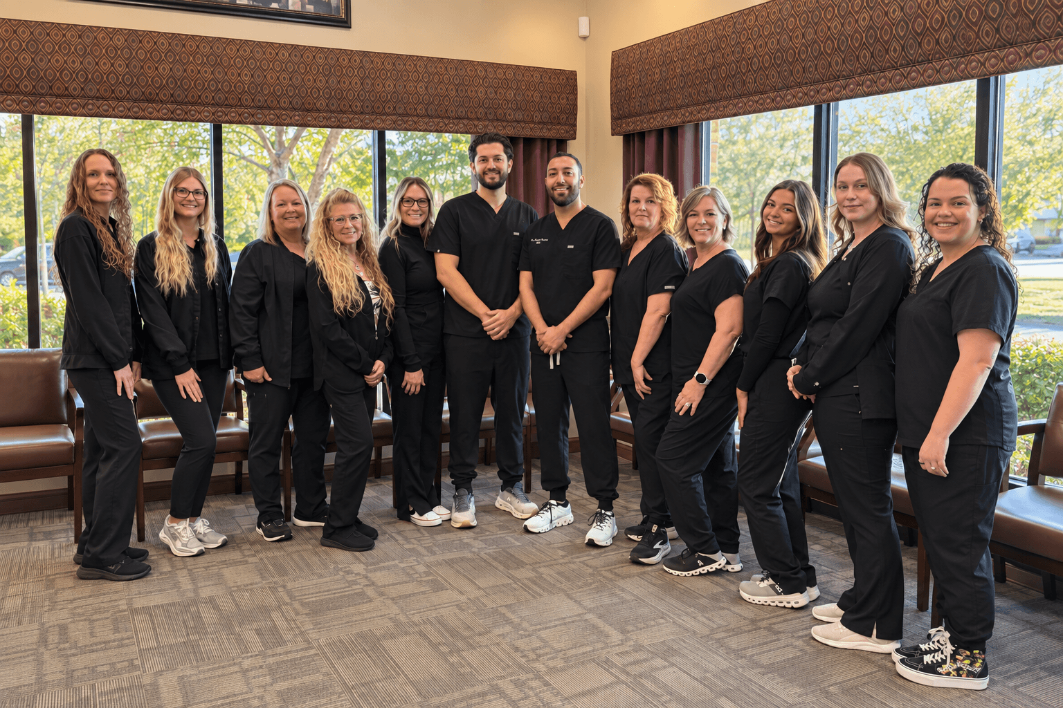 C. Patrick Gray, DDS dental team posing together inside their dental office.
