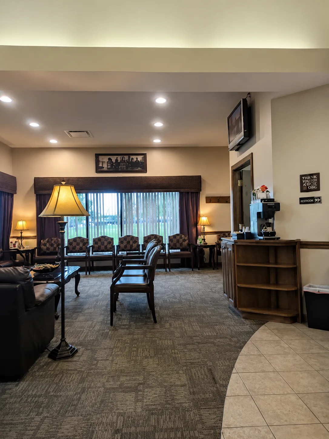 Comfortable C. Patrick Gray, DDS patient waiting room with warm lighting and plush seating