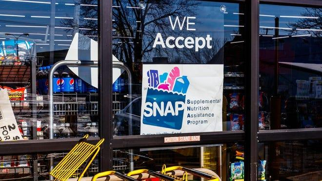 Storefront window displaying a SNAP acceptance sign.