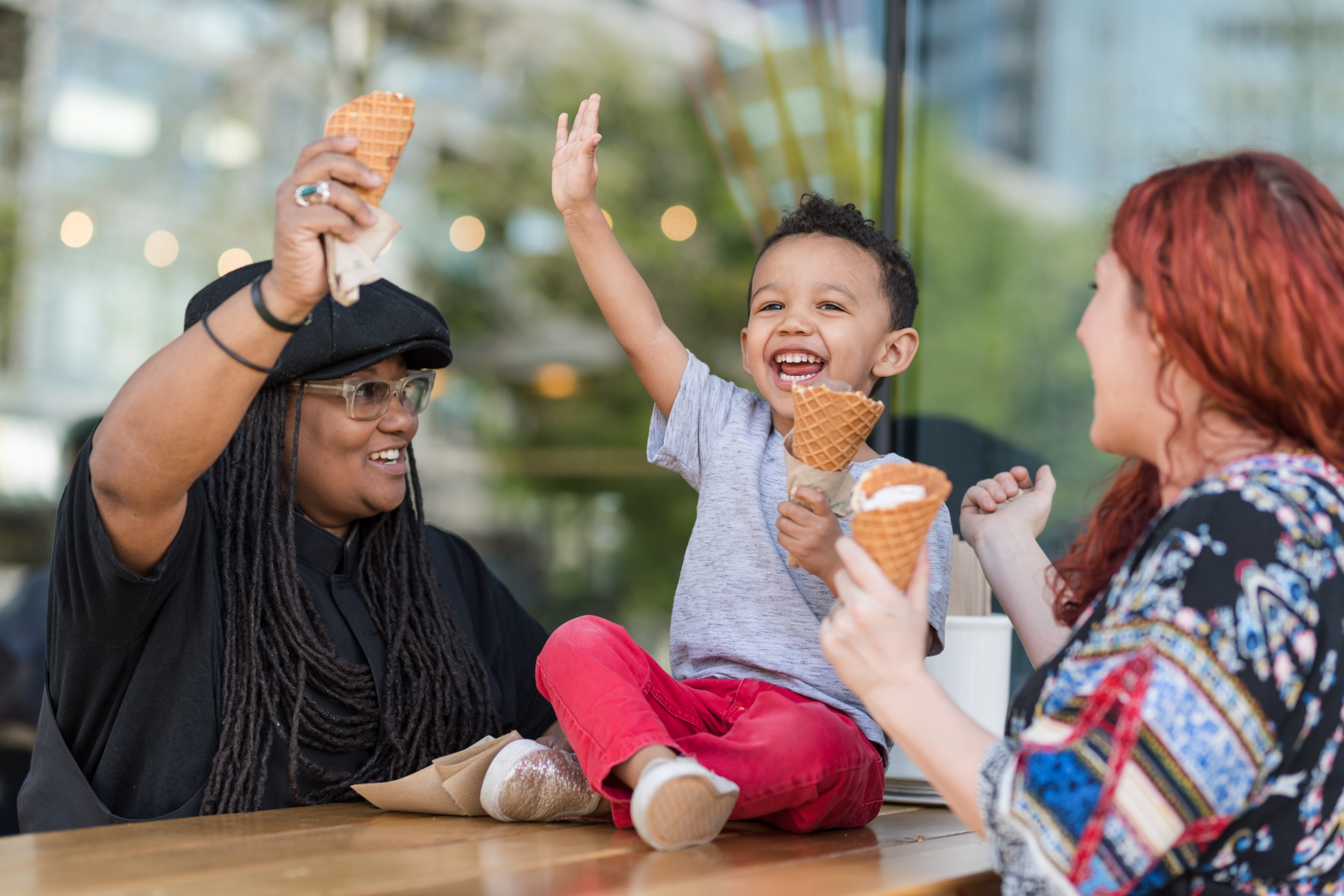 Adults and a child eating ice cream together.