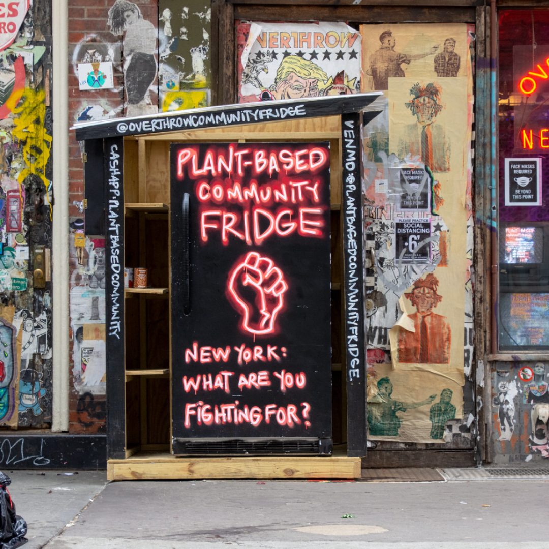 Community fridge with a Plant-Based Community Fridge mural.