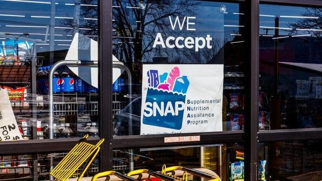 Store entrance with a SNAP acceptance sign.
