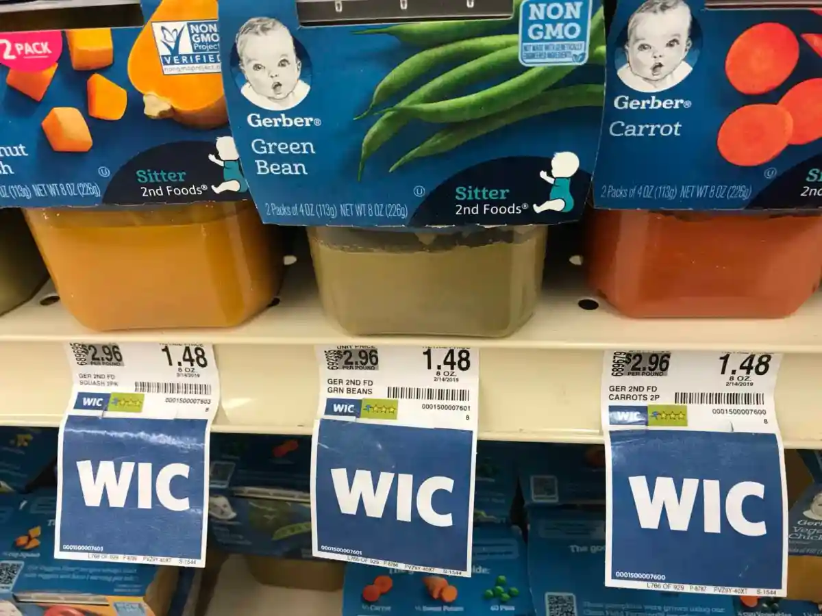 WIC shelf labels below jars of baby food.