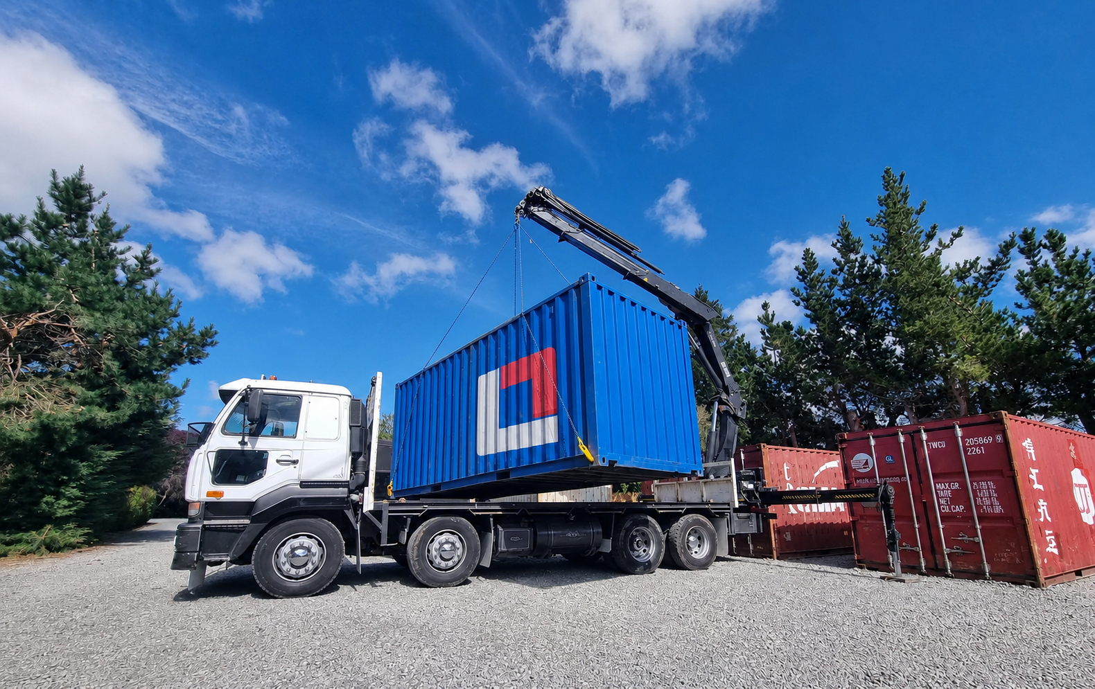 A blue StorePoint container being positioned by the local HIAB team