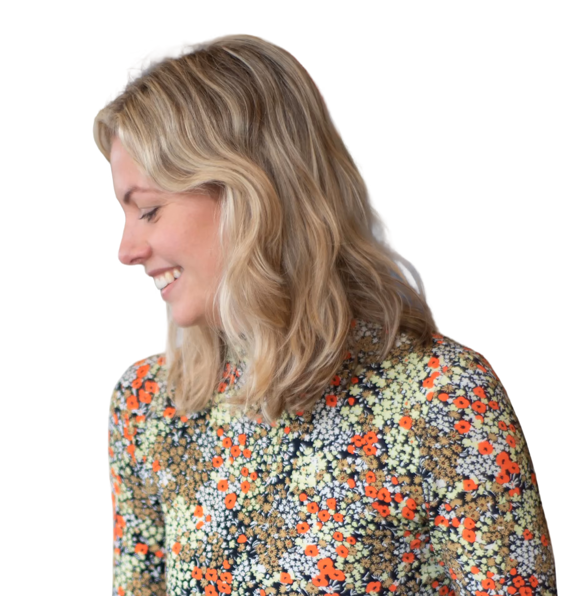 A woman smiling in profile outdoors, framed in an oval