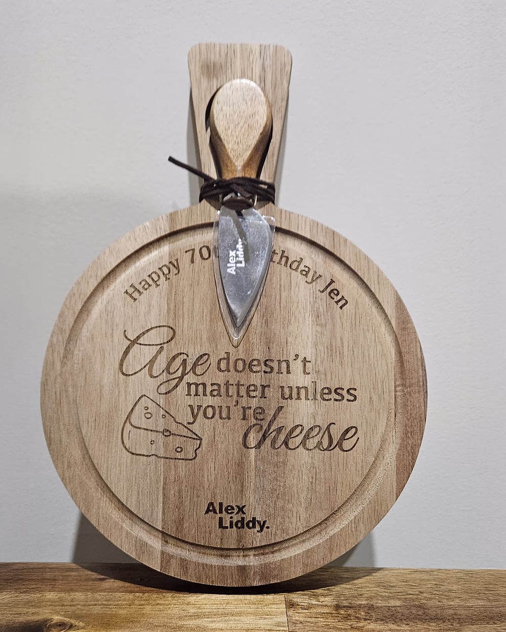 Engraved 70th birthday cheese board with a matching cheese knife tied to the handle