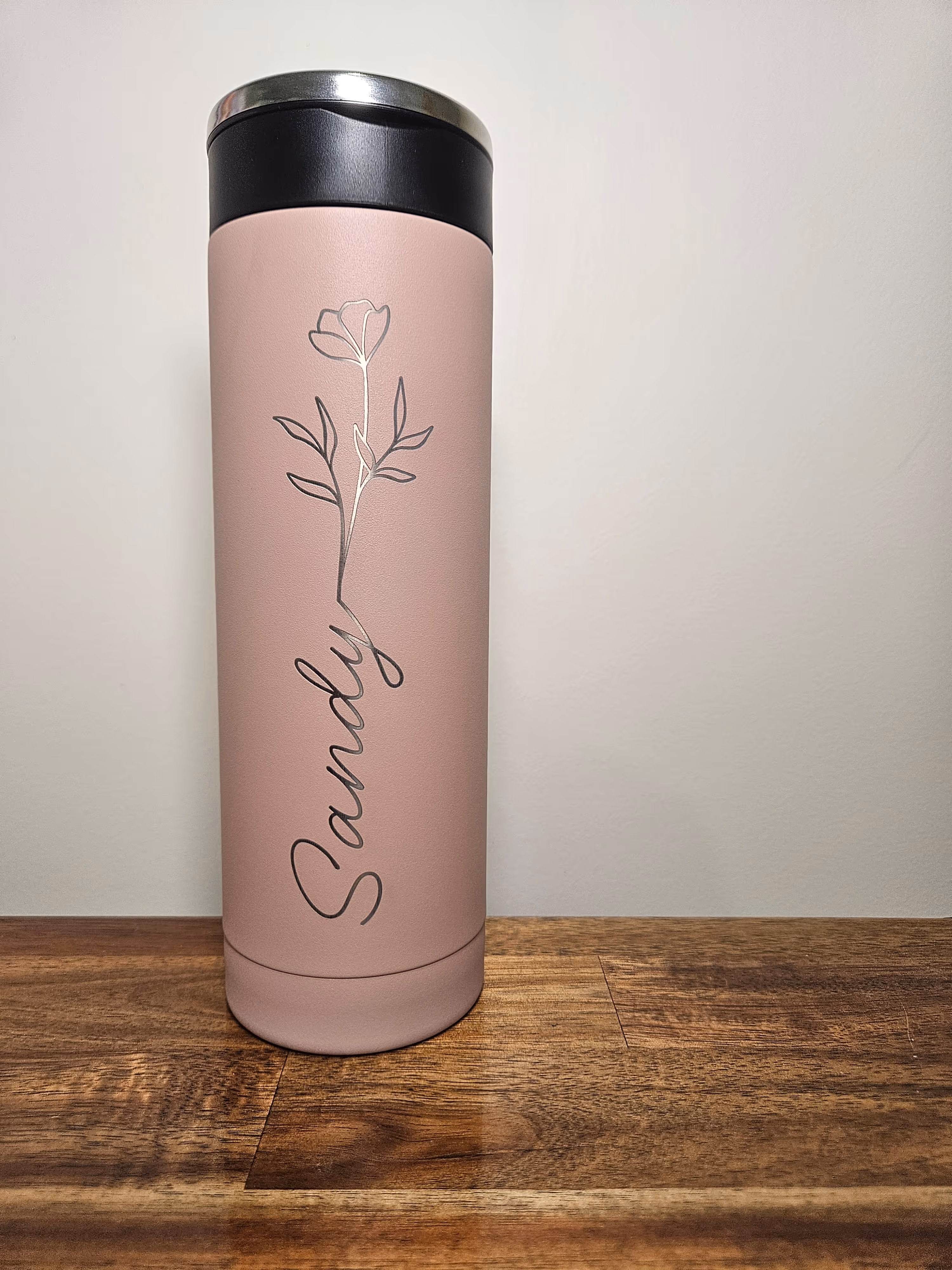 A rose-pink insulated tumbler engraved with a single rose and the name Sandy