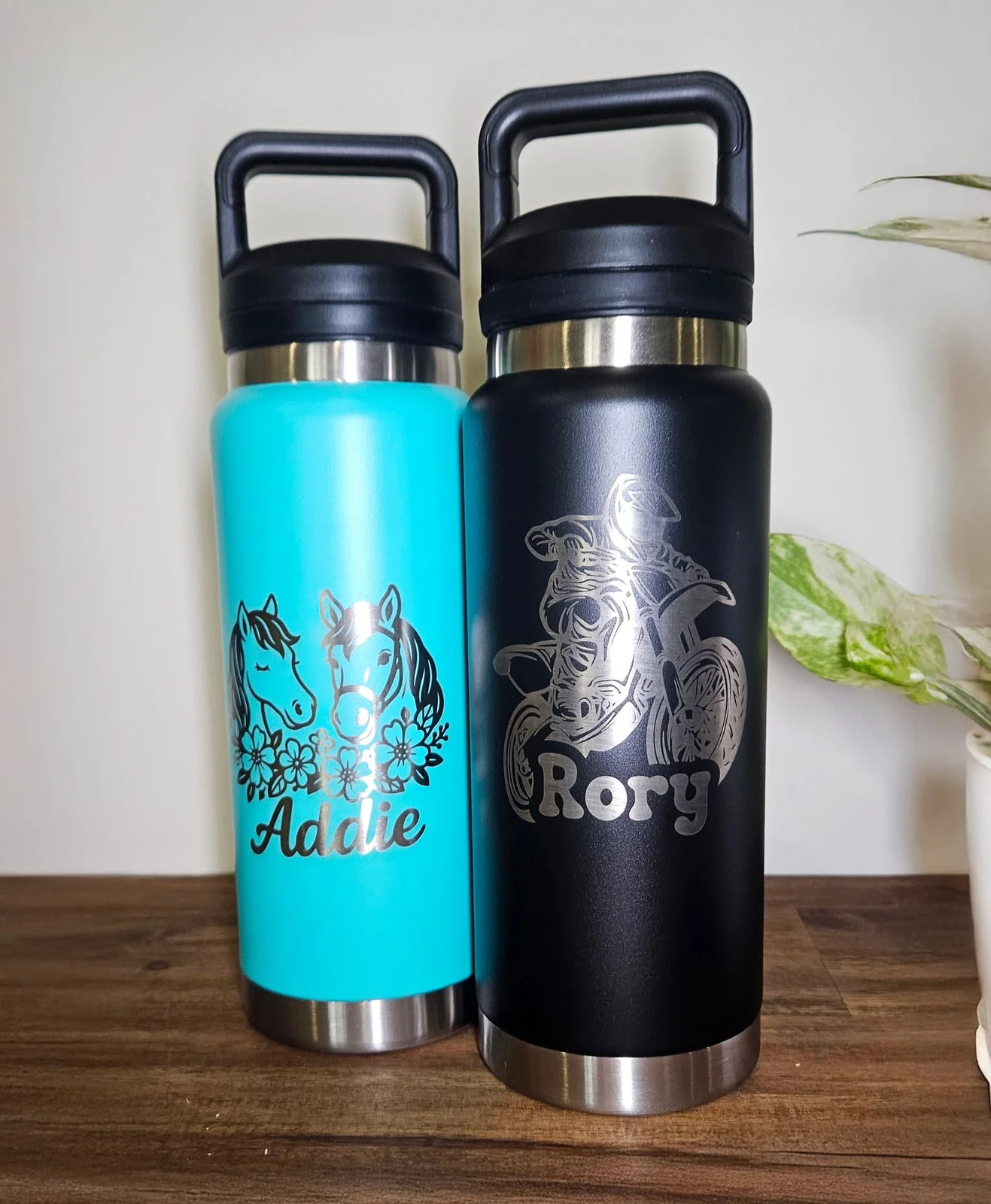 Two engraved drink bottles, one with a horse design for Addie and one with a motorbike design for Rory