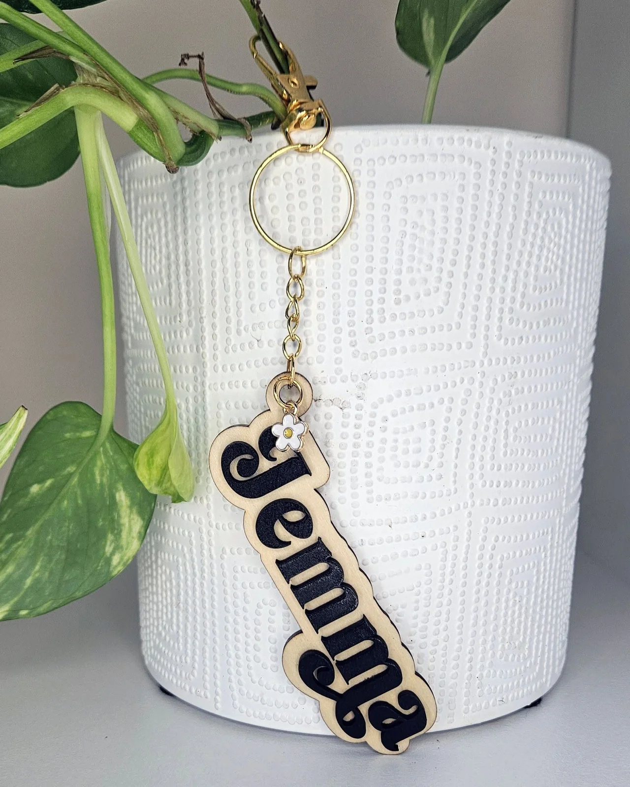A timber keyring engraved with the name Jemma and finished with a small flower