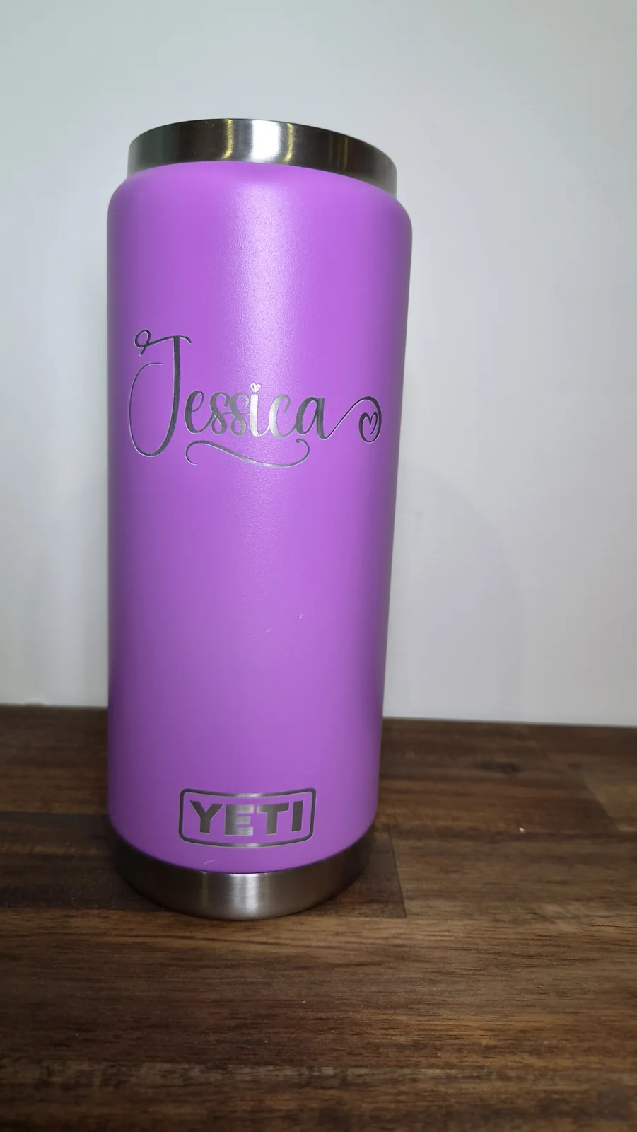 A purple insulated tumbler engraved with the name Jessica in script lettering
