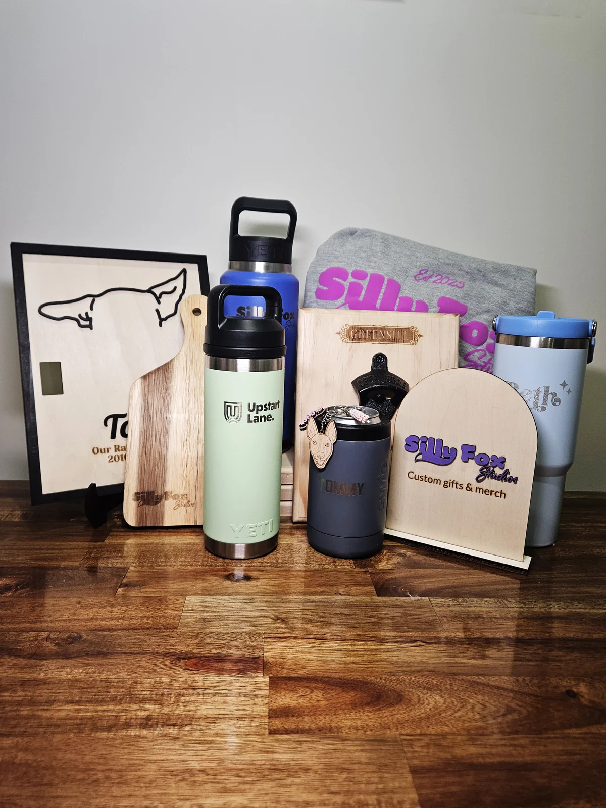 A display of Silly Fox Studios work: engraved boards, bottles, tumblers and signage