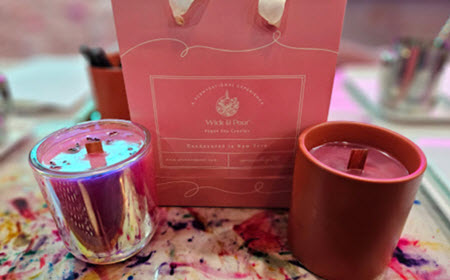 Finished candles and a pink gift bag ready to take home from Wick & Pour