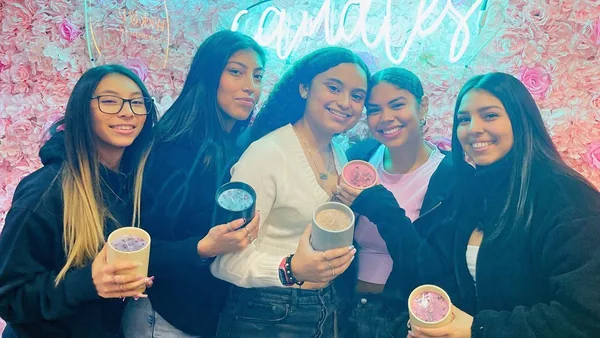 Group of friends smiling with their handmade candles at Wick & Pour in NYC