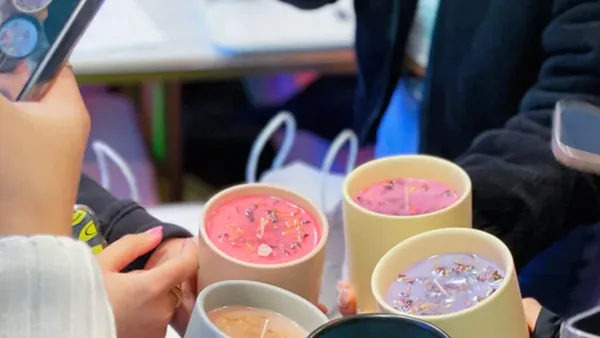 Guests photographing their colorful handmade candles at Wick & Pour in NYC
