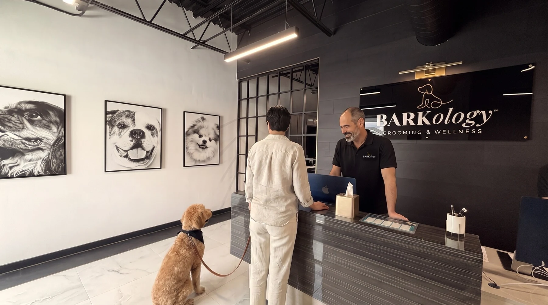 Illustrative reception conversation between a BARKology greeter and a dog owner