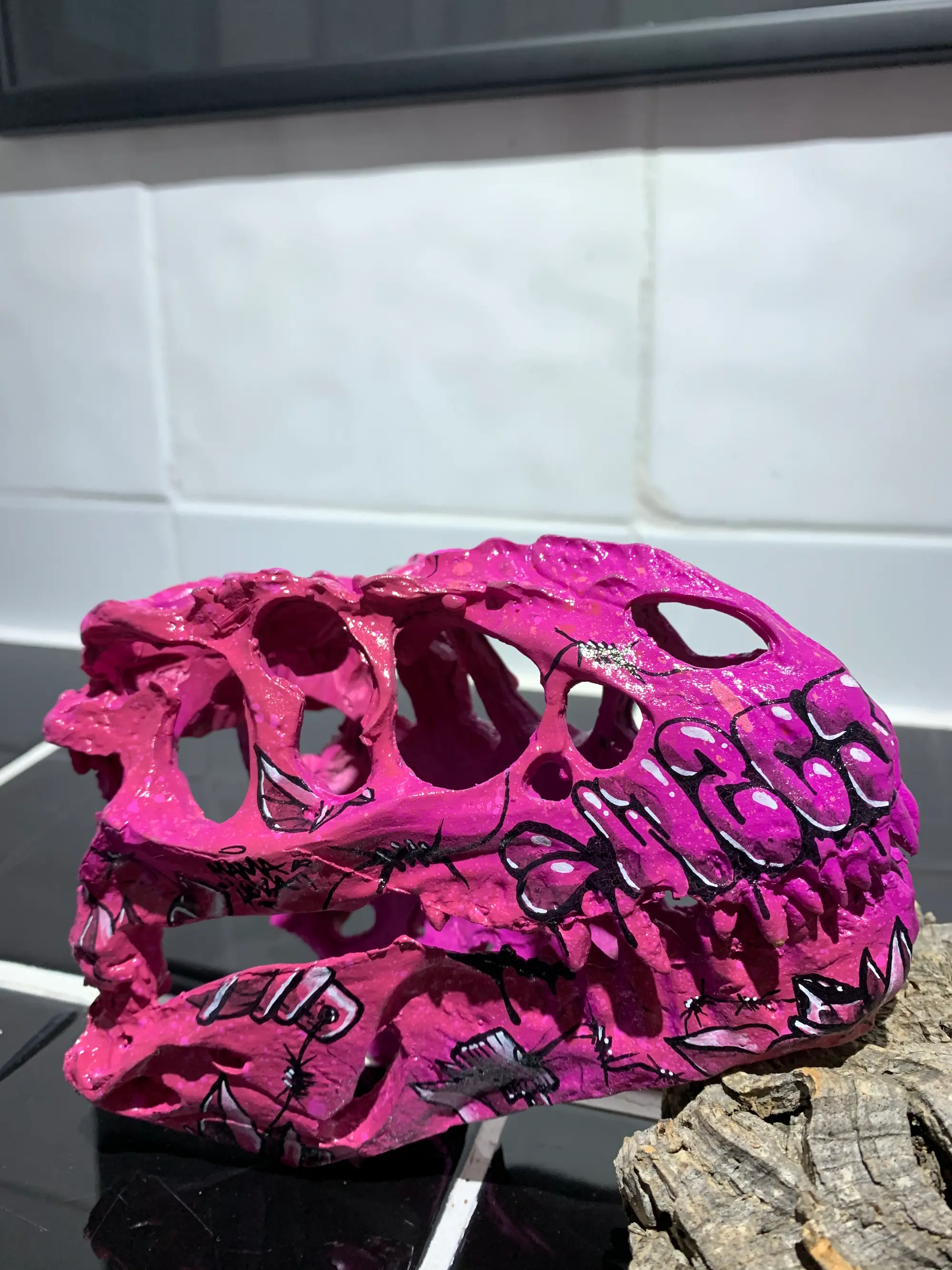 Exposition à la galerie Noir & Blanc, 2020 : crâne de dinosaure en résine peint en rose, recouvert de lettrage graffiti