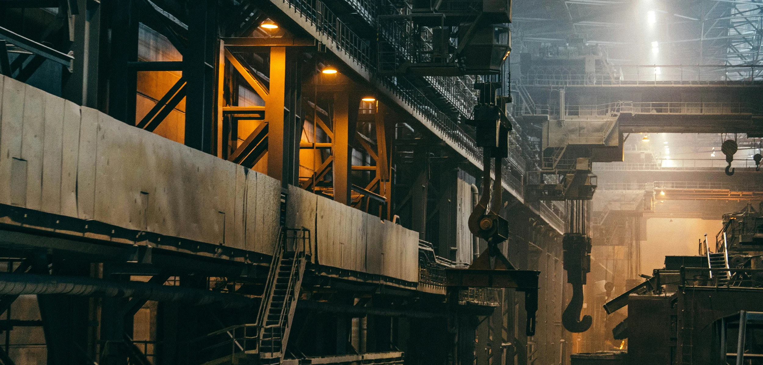 Industrial steel production facility with machinery and overhead cranes