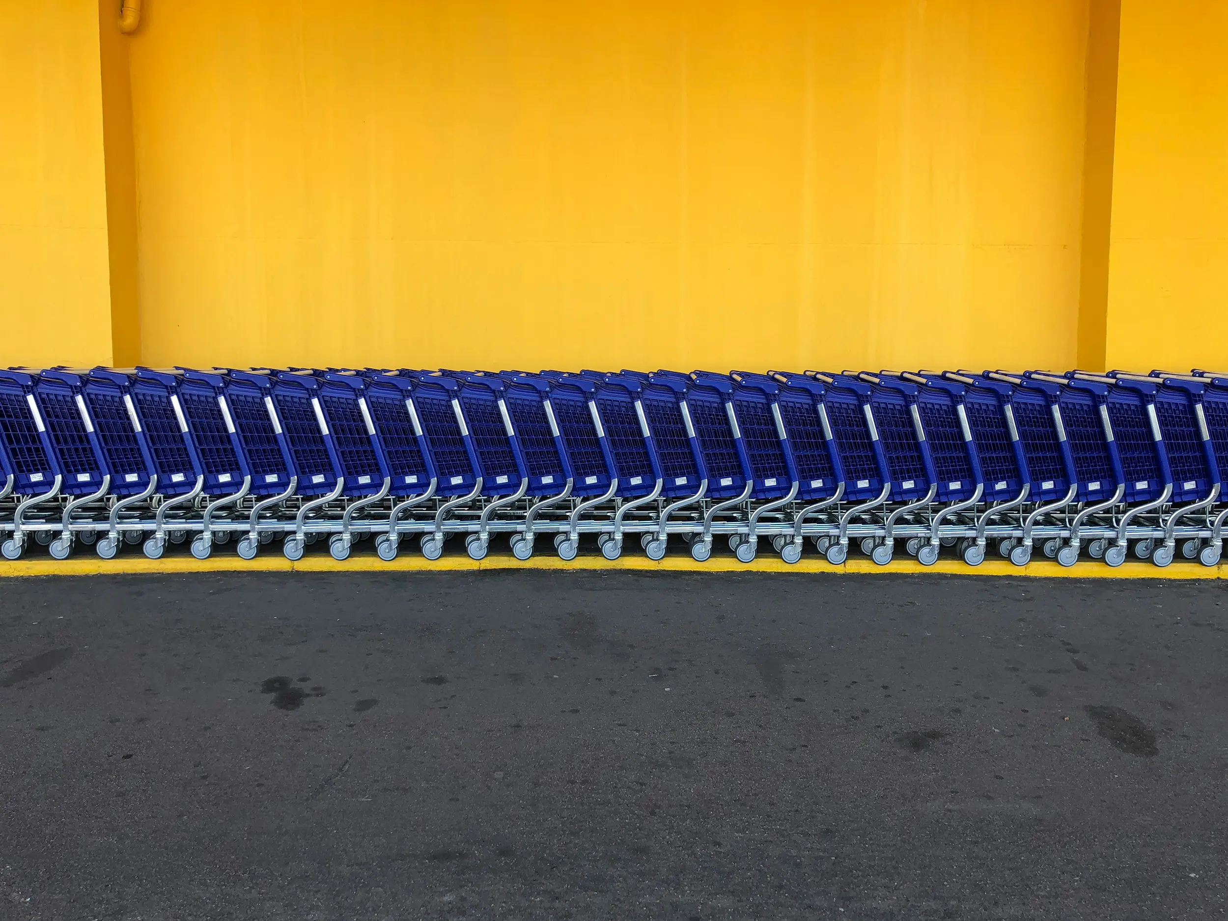 Long row of shopping carts outside a retail store