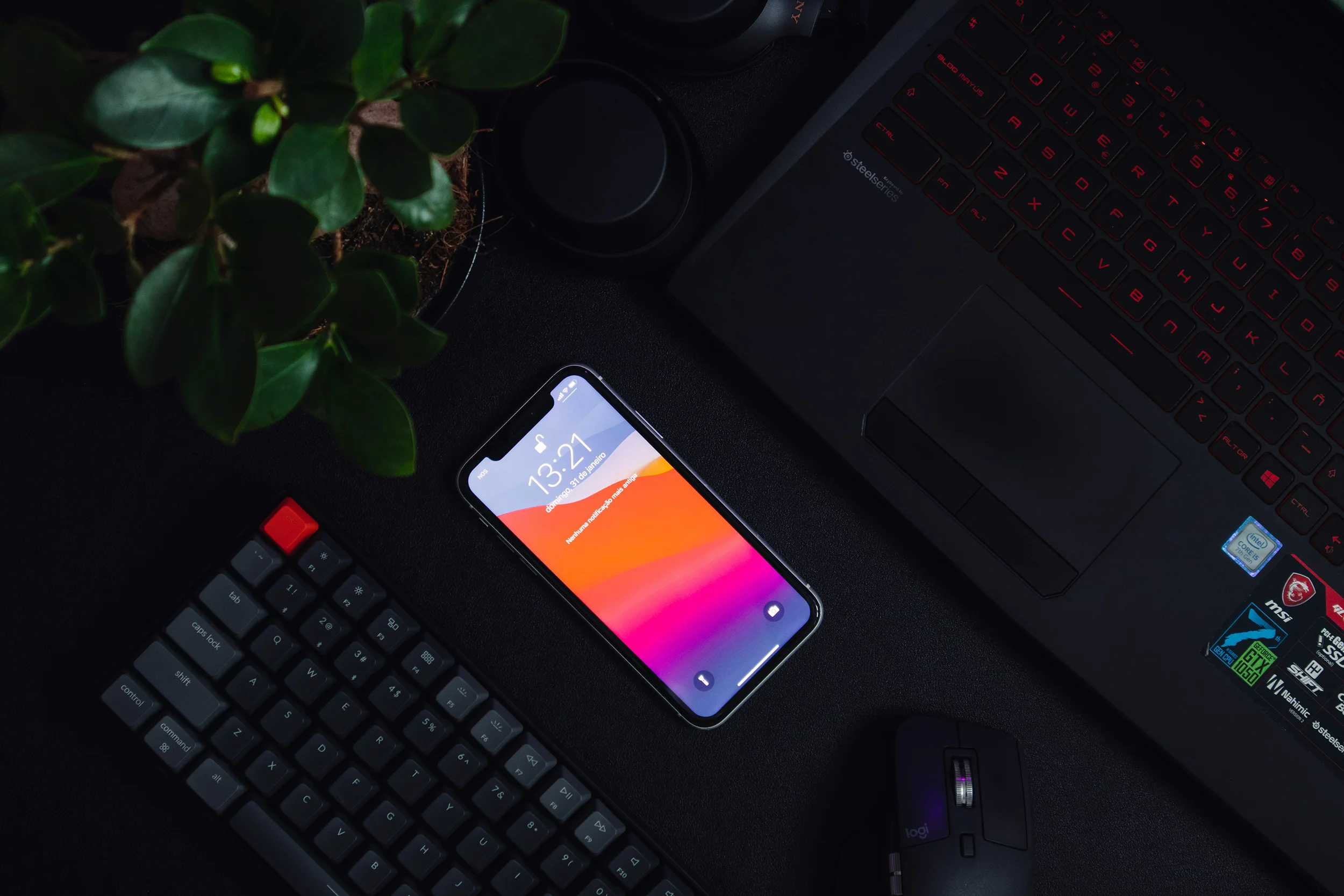 Digital workspace with laptop, smartphone and keyboard