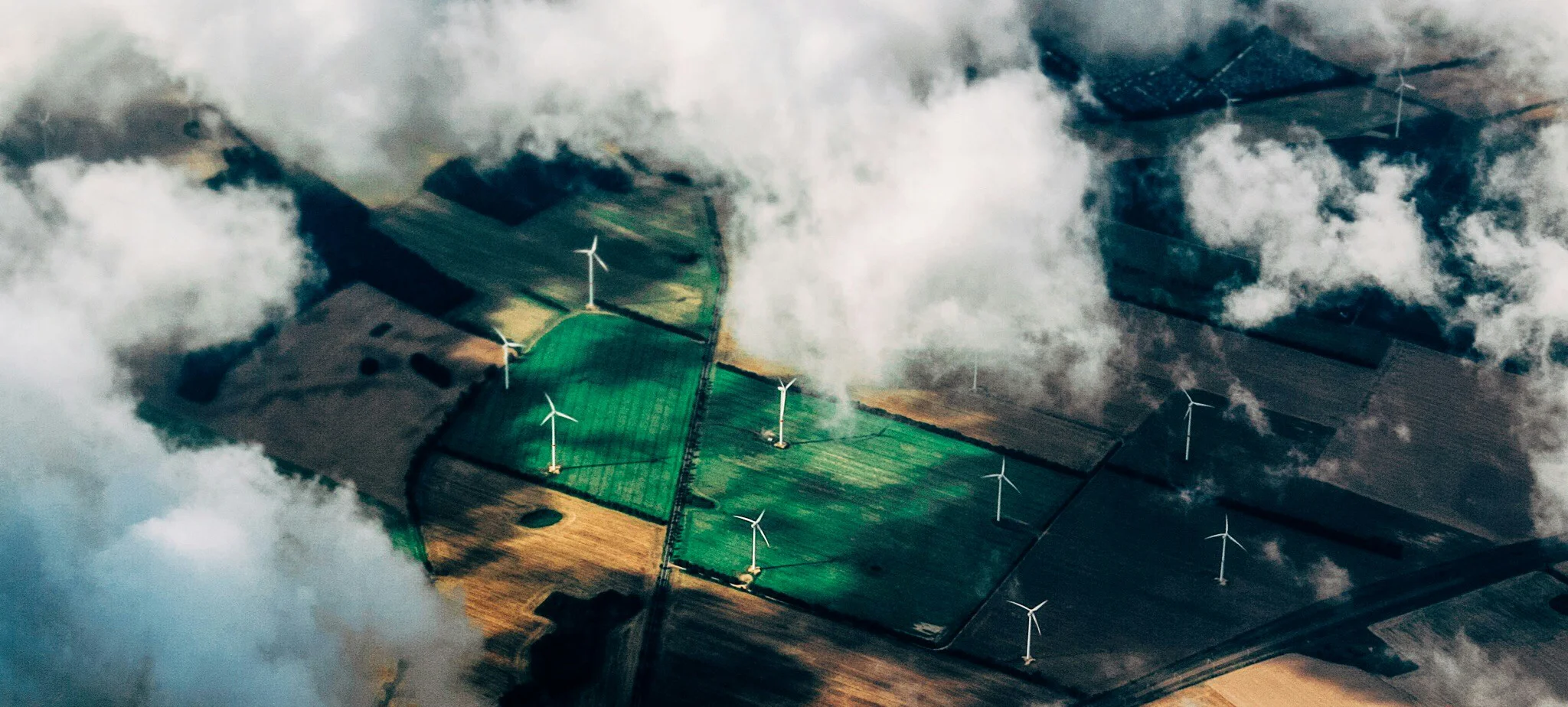 Wind turbines generating renewable energy across agricultural fields