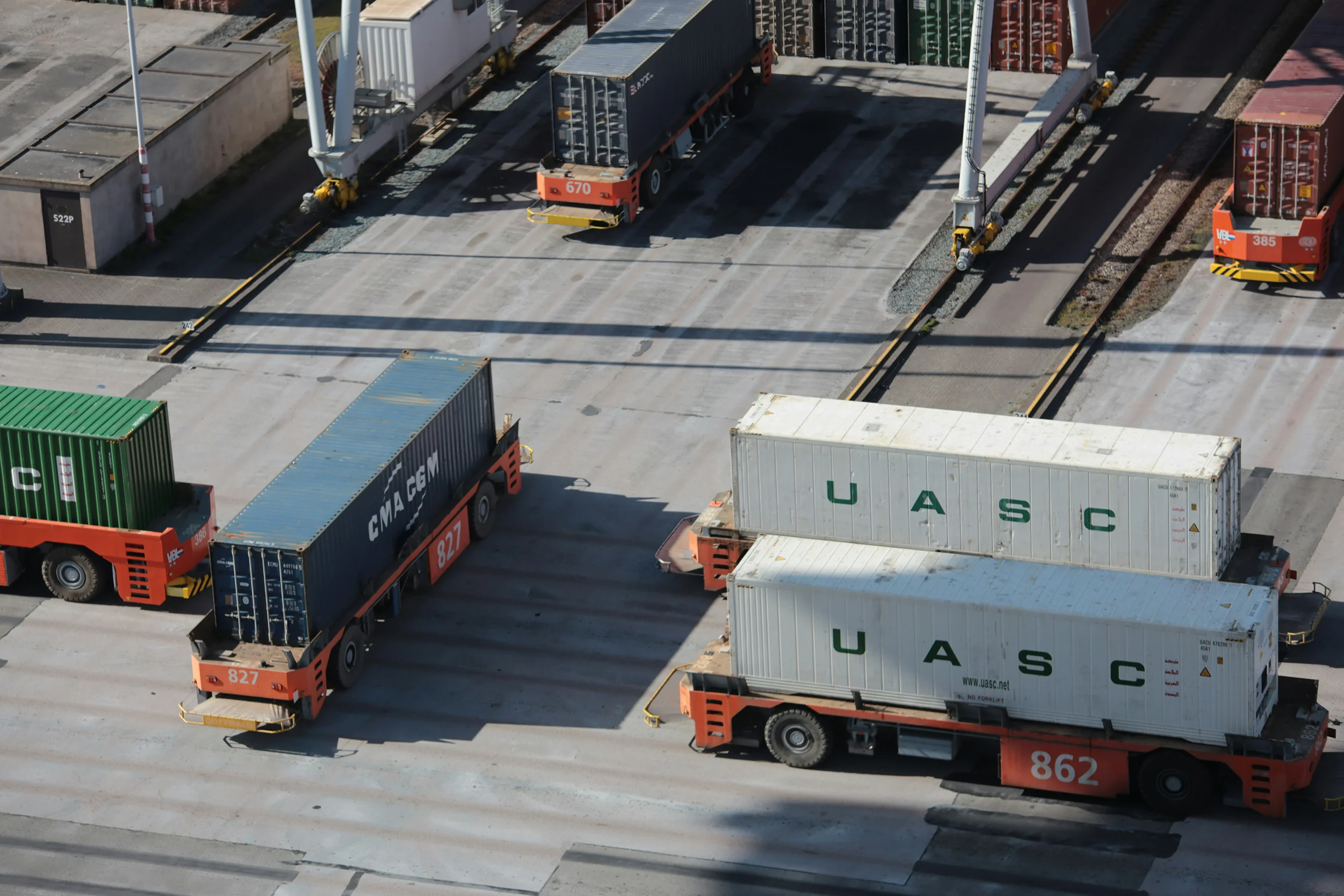Container trucks transporting cargo at a logistics terminal