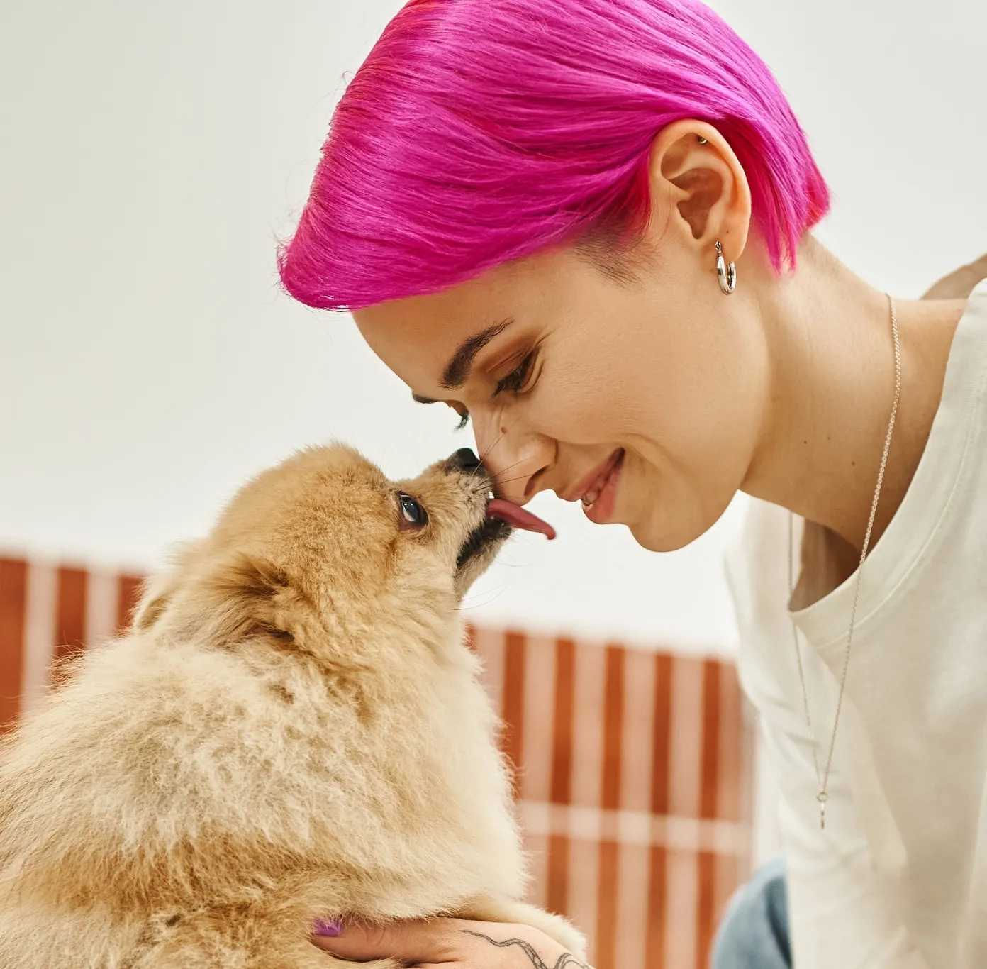 a woman playing with her dog