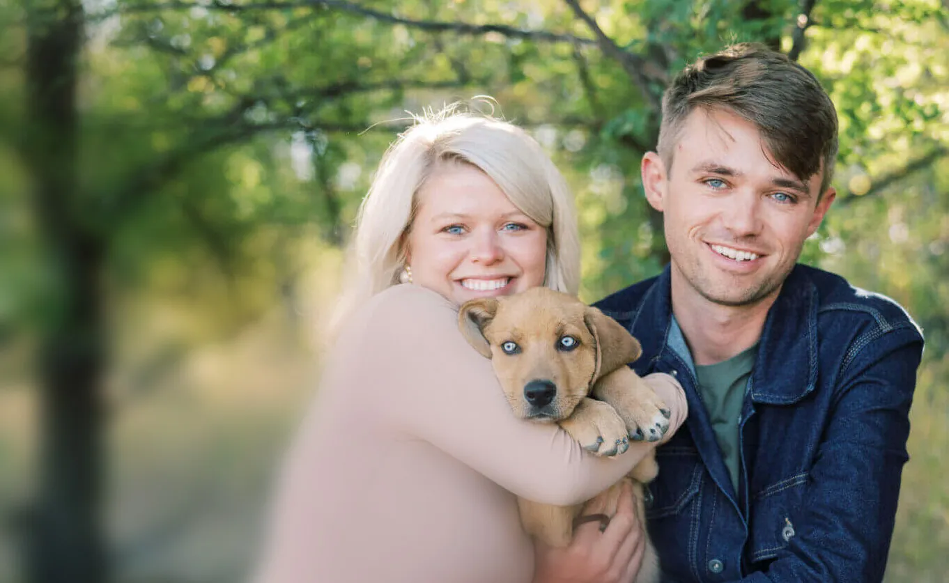 a photo of a couple with their dog