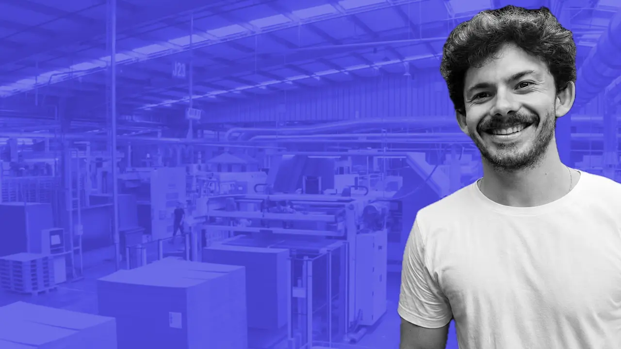 La Maillecotech team member on the knitting workshop floor in Tourcoing, with knitting machines running behind.