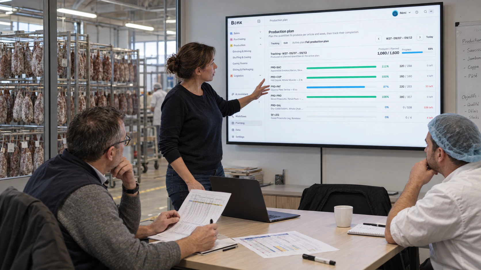 Team reviewing a Bonx production plan on a meeting room screen next to the production floor.