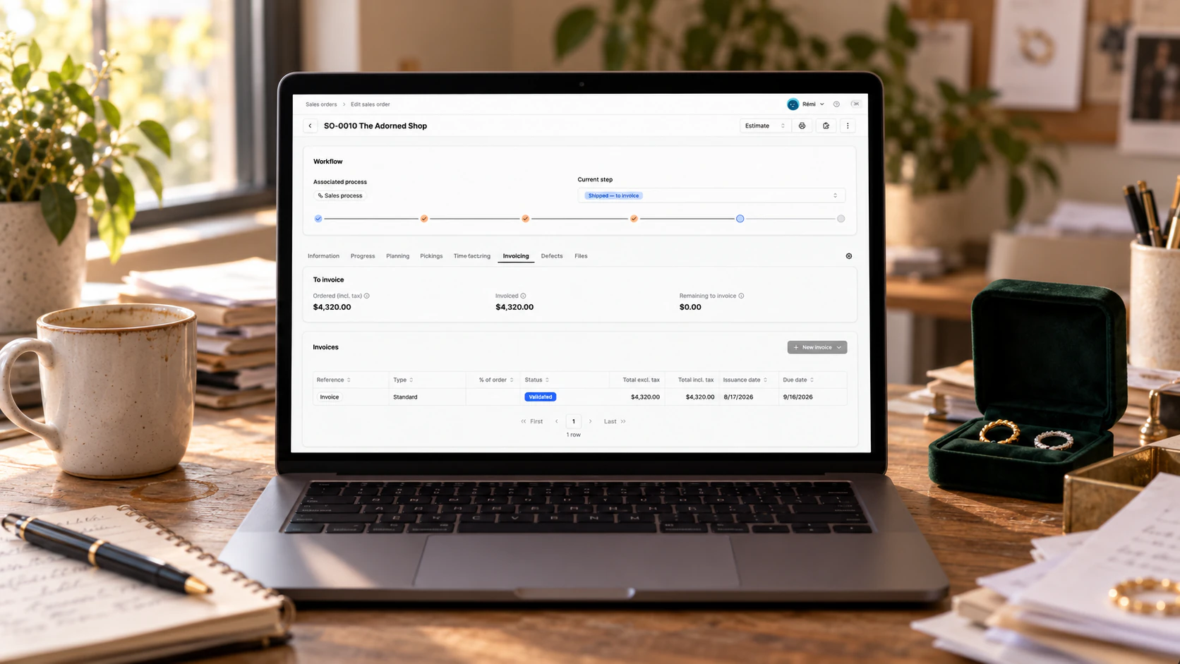 Laptop showing a Bonx sales order and its workflow steps on a jeweller's desk.