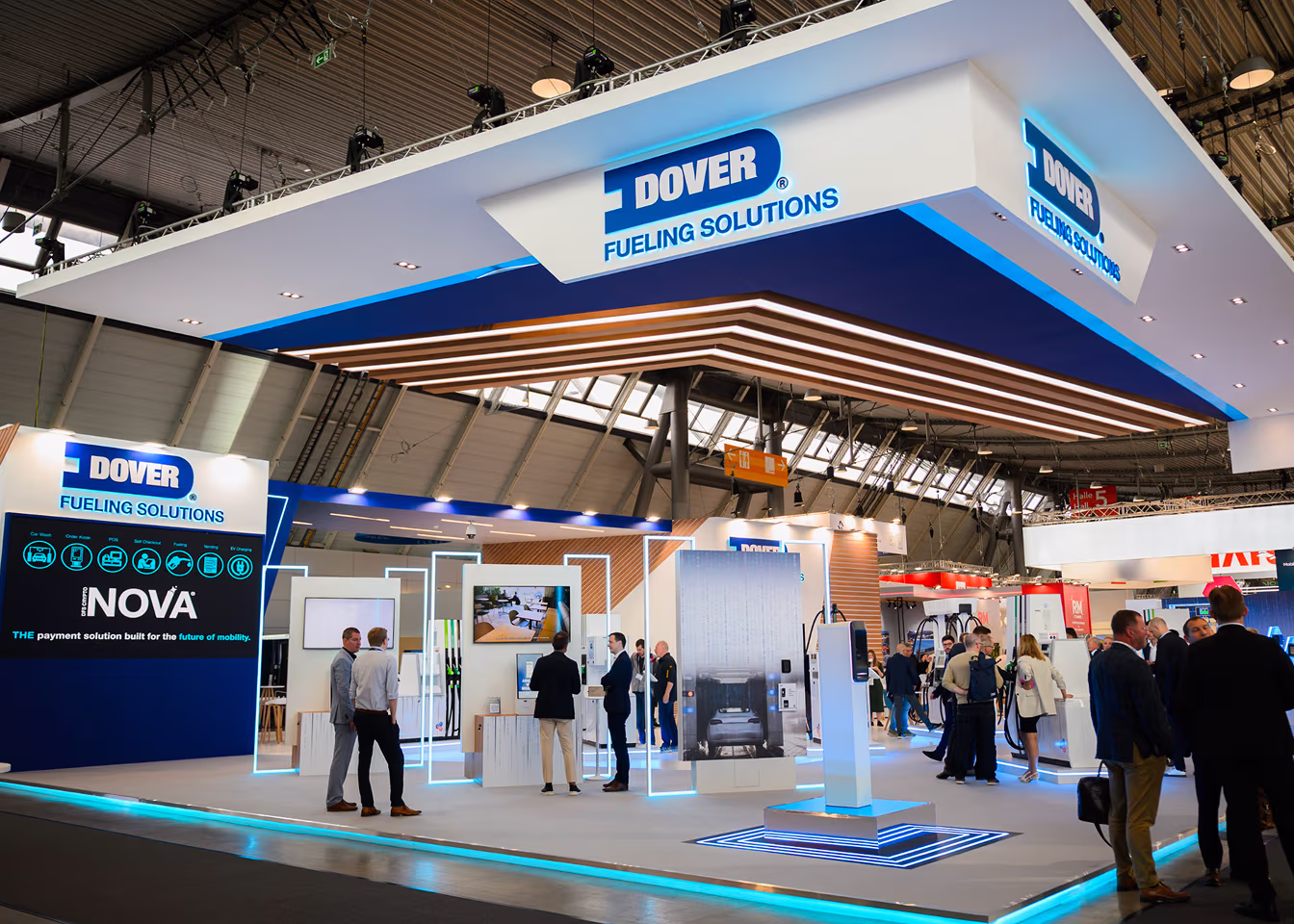 Trade show booth for Dover Fueling Solutions with people interacting and digital displays.