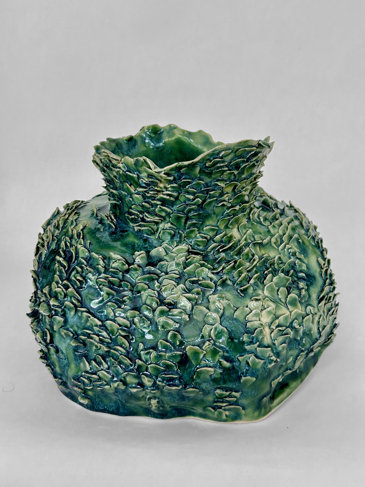 Scaled green ceramic vessel by Consuelo Becerra turned to show the shoulder and rim, view 4 of 6
