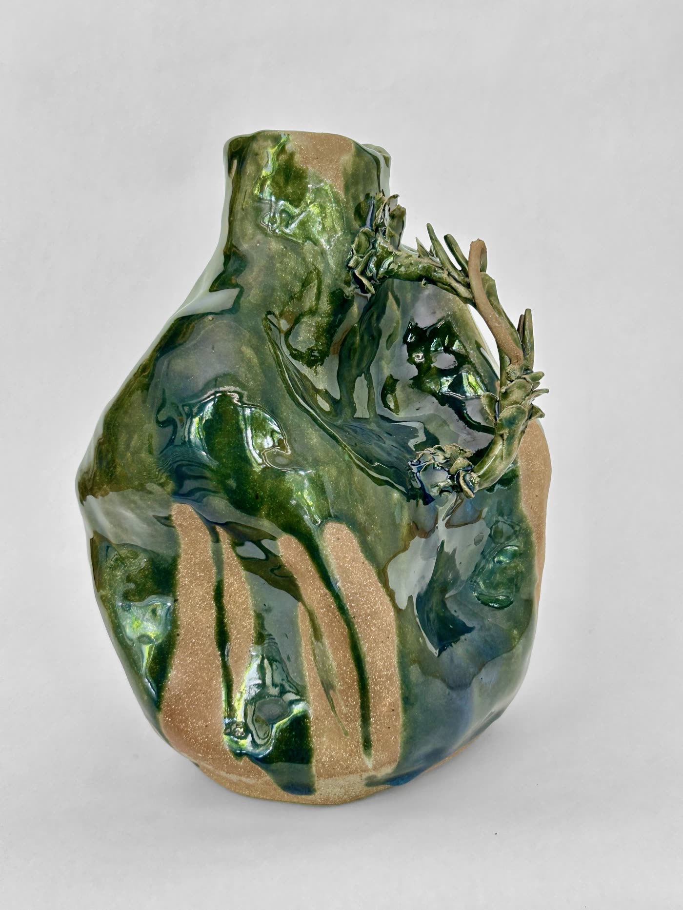 The same ceramic jar by Consuelo Becerra from the opposite side, showing vertical glaze drips over unglazed clay, view 2 of 4