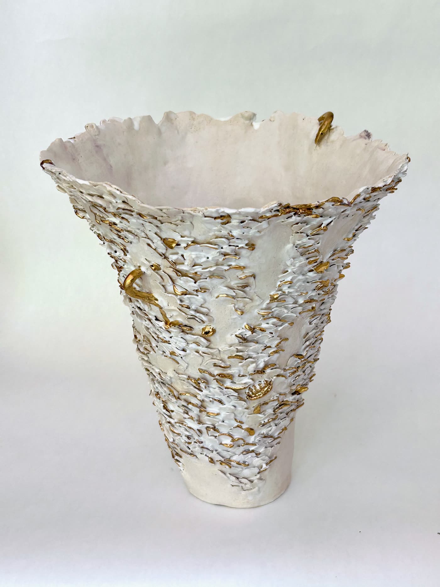 Looking into the mouth of the white flared vessel by Consuelo Becerra, with the smooth glazed interior against the encrusted rim, view 4 of 8