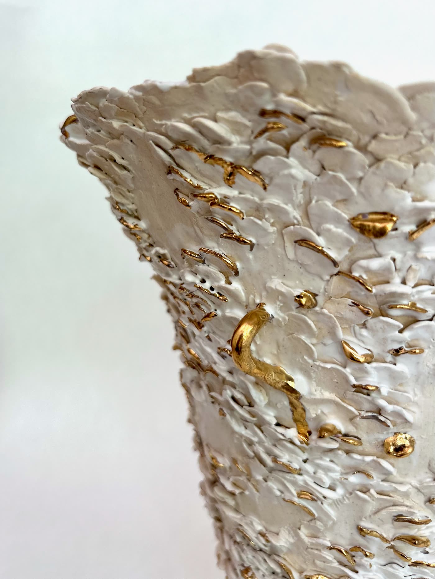 Detail of the applied white petals and gold lustre on the flared vessel by Consuelo Becerra, view 6 of 8